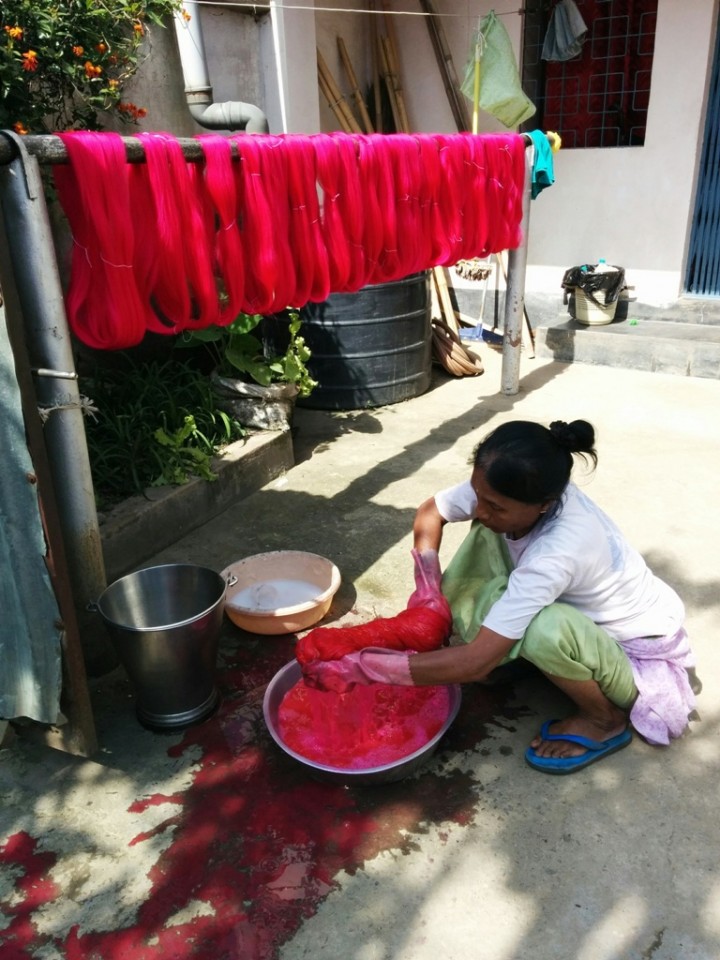 A woman applies dye