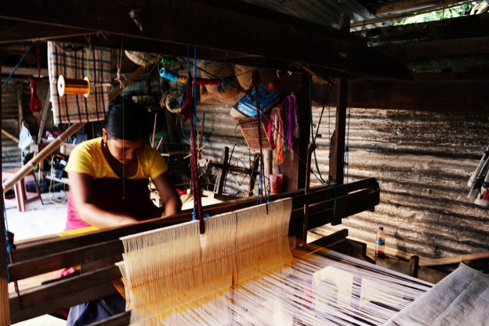 A weaver at her loom